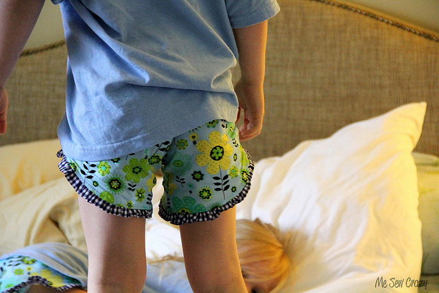 A kid wearing pj shorts with ruffled trim