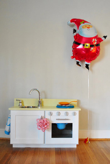 Kitchen cabinets recycled into a play kitchen, painted white and yellow