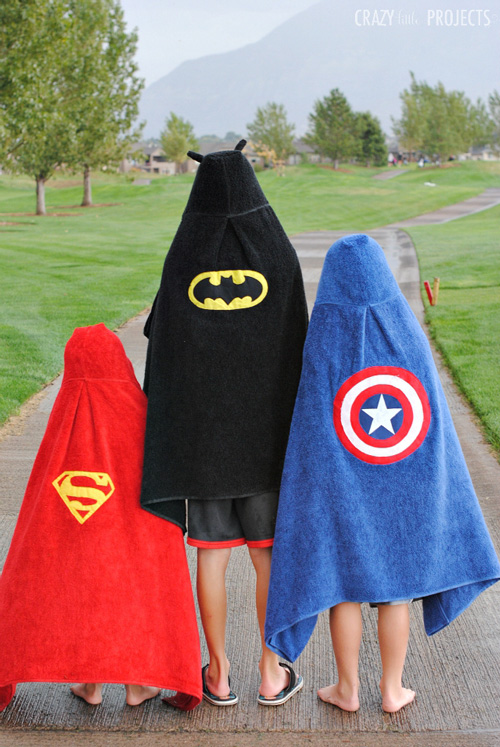 Boys wearing superhero hooded towels