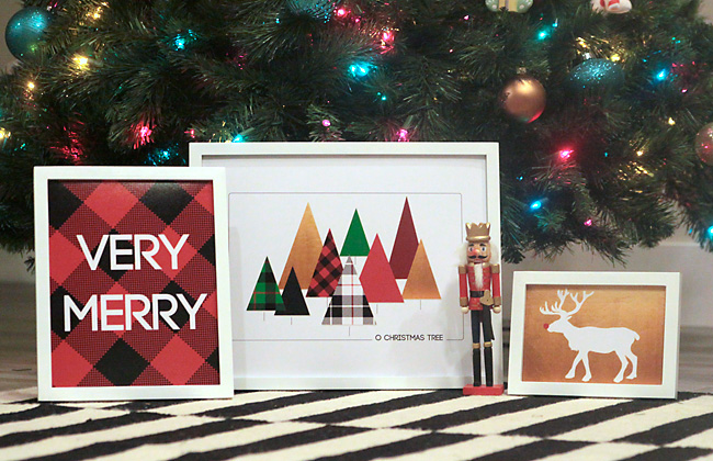 Christmas printables in frames by a Christmas tree