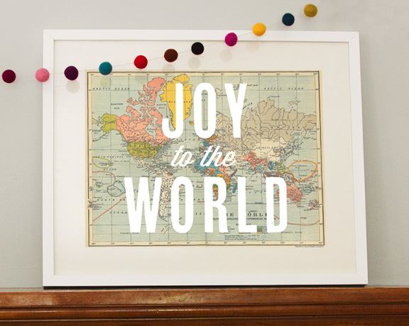 Print of a map with Joy to the World written over it in white text