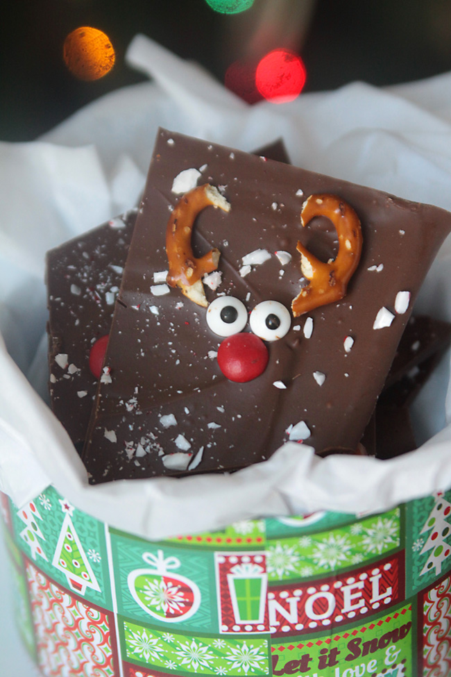 A piece of chocolate peppermint bark with reindeer face on it