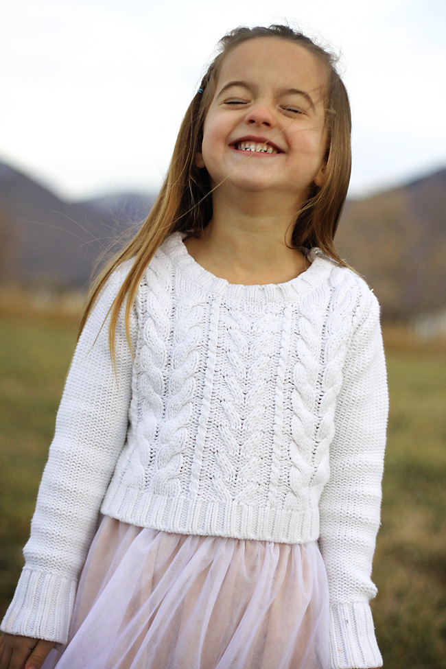 A little girl smiling in a field