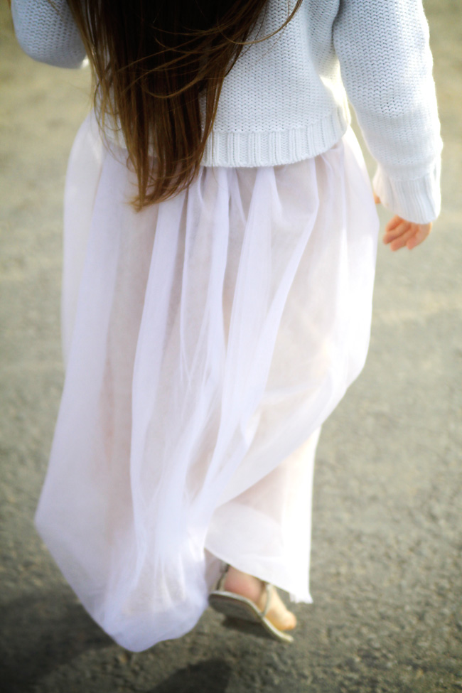 A closeup of a long pink tulle skirt