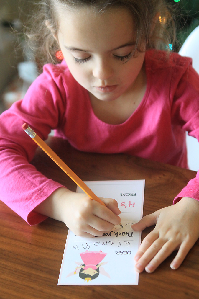 A little girl filling out a thank you card