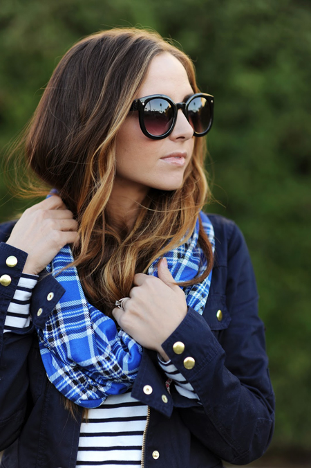 A woman wearing sunglasses and a easy to sew blue plaid scarf