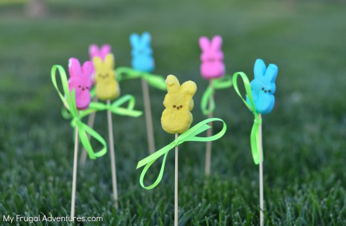 Peeps marshmallows on skewers poked into the grass