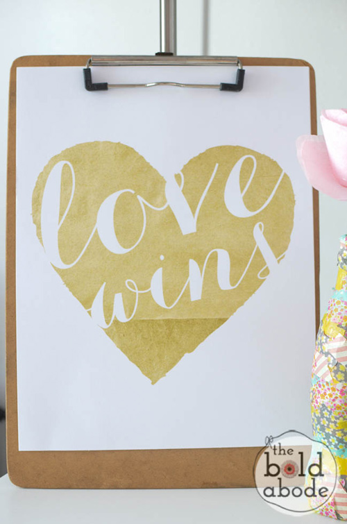 Art print with gold heart and the words \"love wins\"