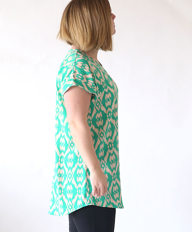 A woman in a green tunic top made from a pdf sewing pattern