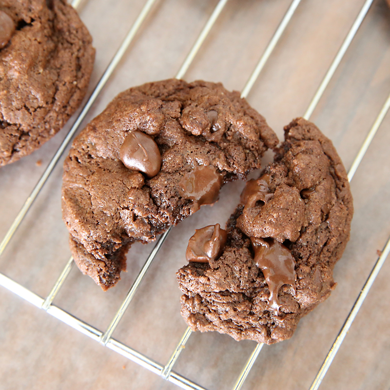 Chocolate cake mix cookie broken in half on a cooling rack