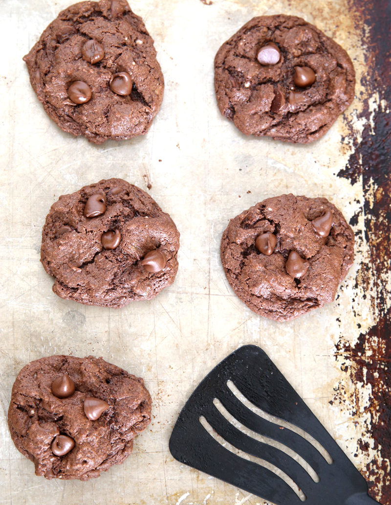 Double chocolate cake mix cookies on a cookie sheet with spatula