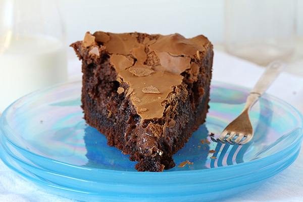 Slice of chocolate ooey gooey cake on a plate