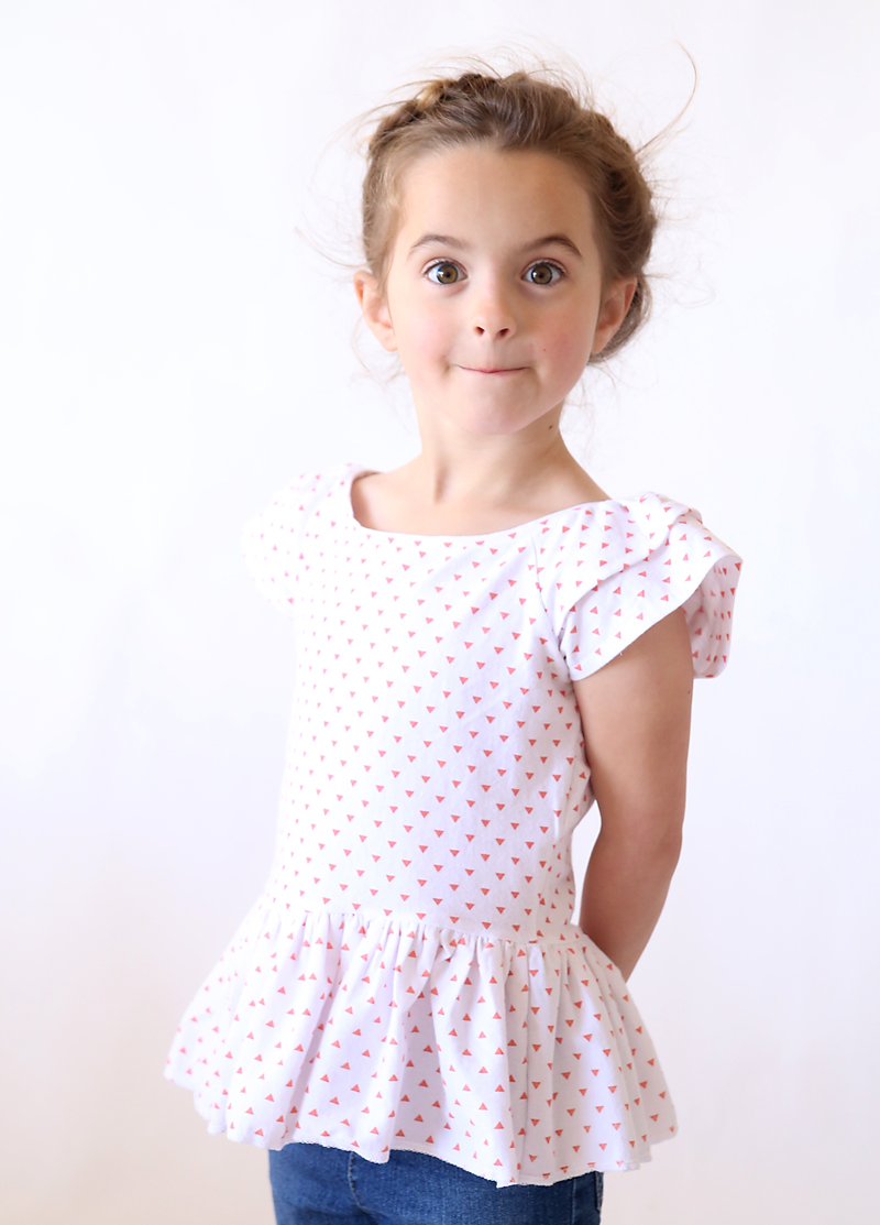 little girl wearing a polka dot shirt made from a free sewing pattern