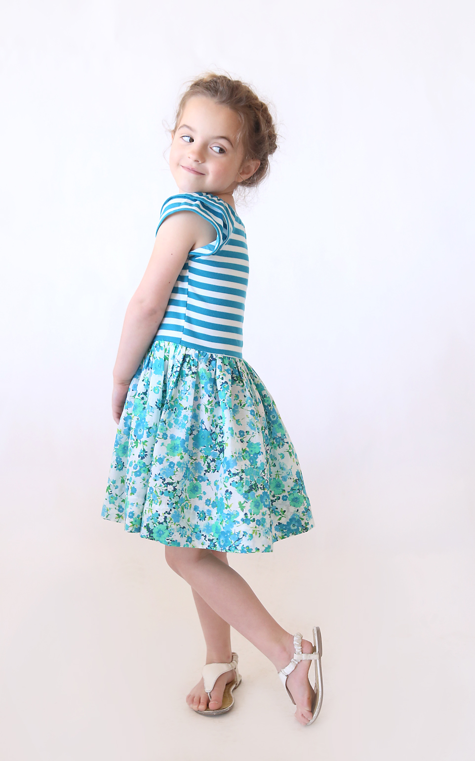 A little girl in a blue dress made from a pdf sewing pattern