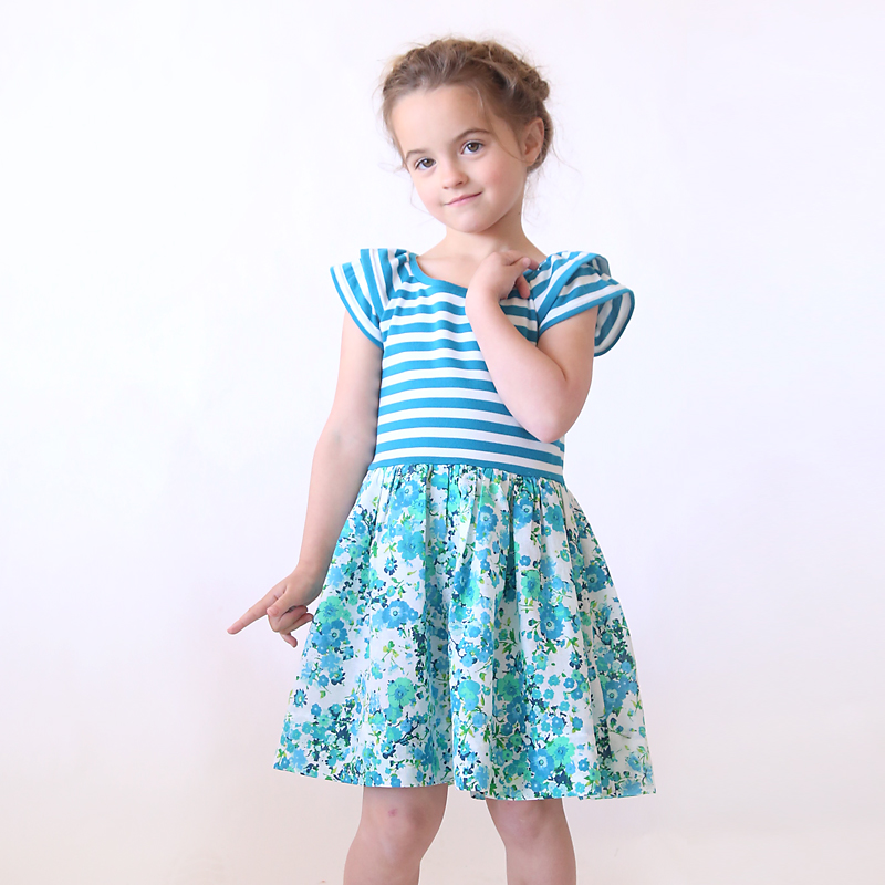 A little girl posing for a picture wearing a dress made from a sewing pattern