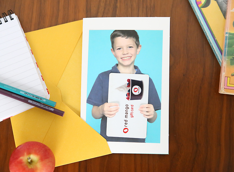 Photo of a boy holding a gift card