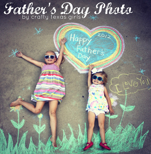 Little girls laying on the sidewalk with Father\'s Day chalk art