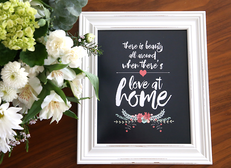 love at home art print, framed, next to flowers on a table