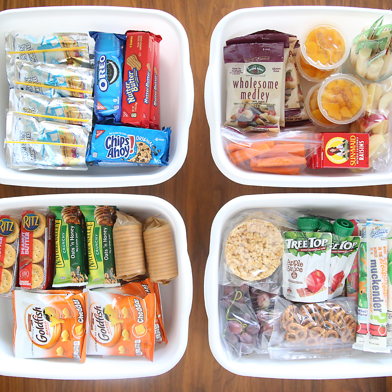 Bins full of snack items, including fruit, carrots, trail mix, pretzels, crackers, etc.