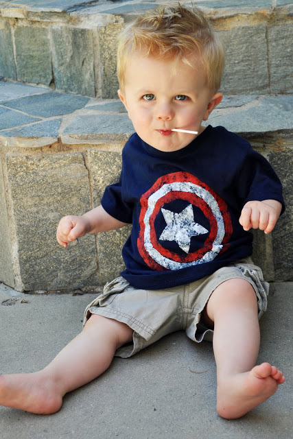 A baby wearing a captain america t-shirt