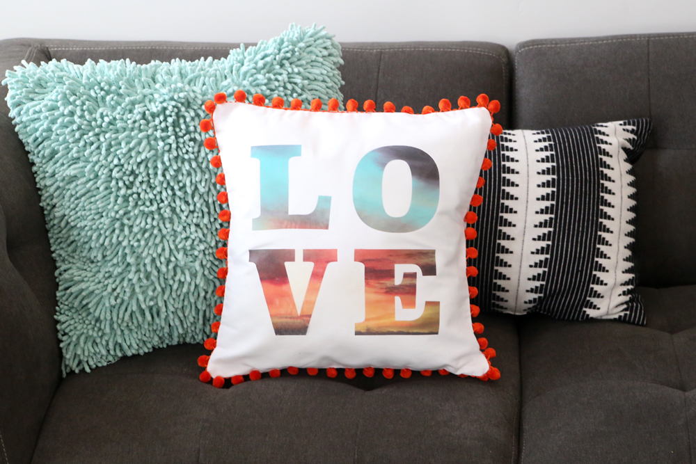 Typographical throw pillow on a couch