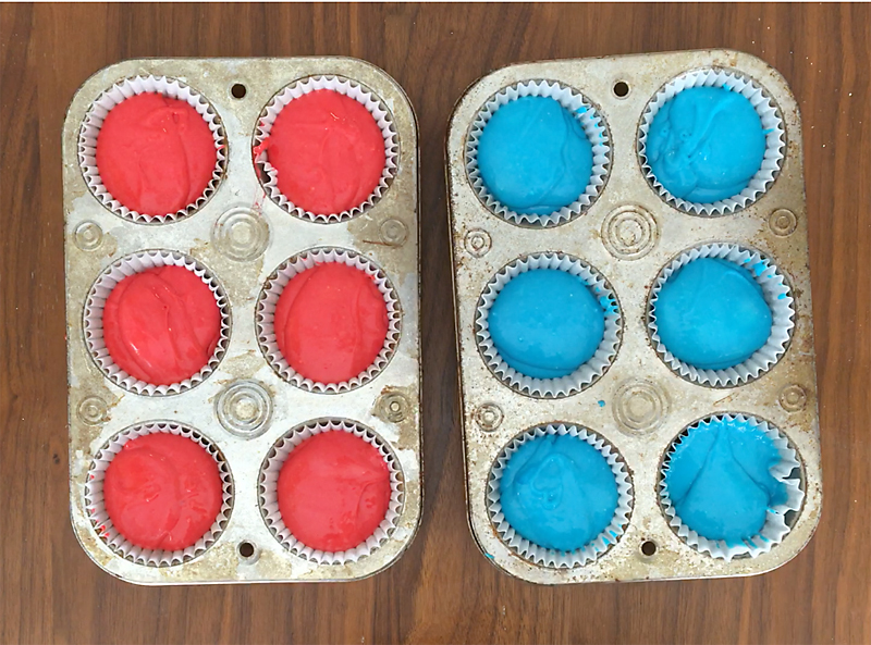 Red and blue batter in cupcake tins