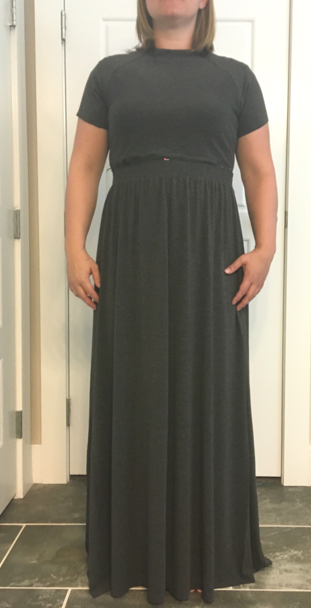 Woman wearing a maxi dress, marking where the waistband should be