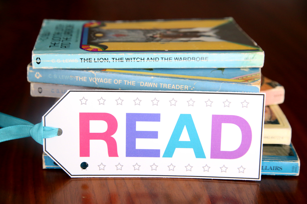 A stack of books with a punchcard bookmark