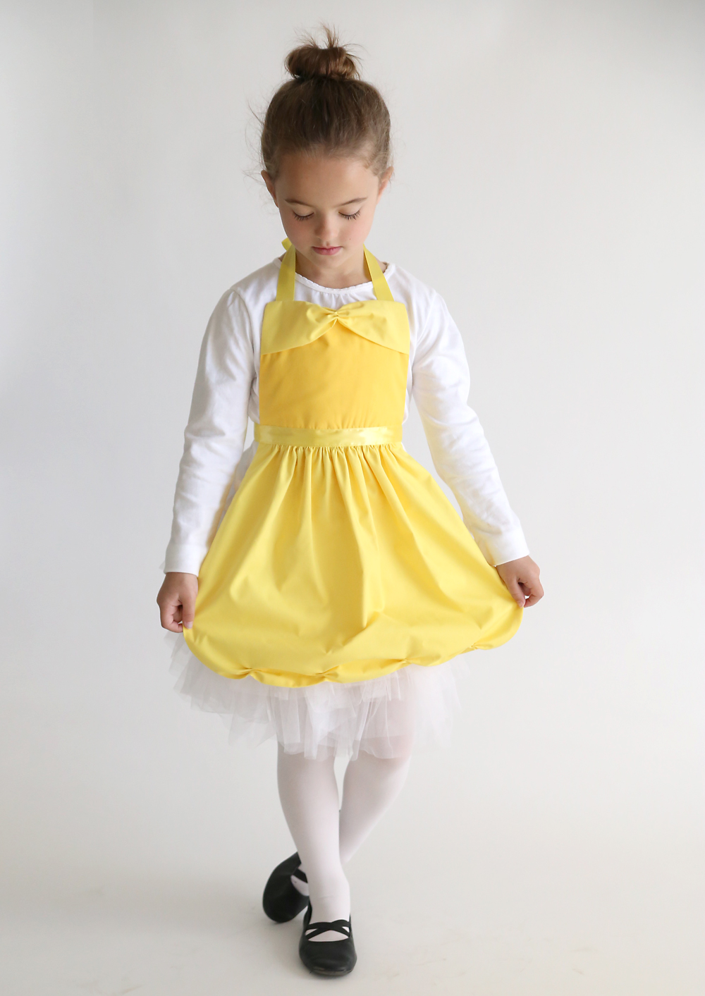A little girl wearing a Belle dress up costume made from a free pdf sewing pattern
