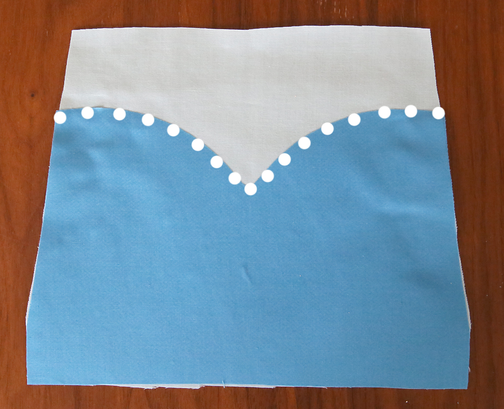 Darker bodice placed over light blue bodice, seam marked