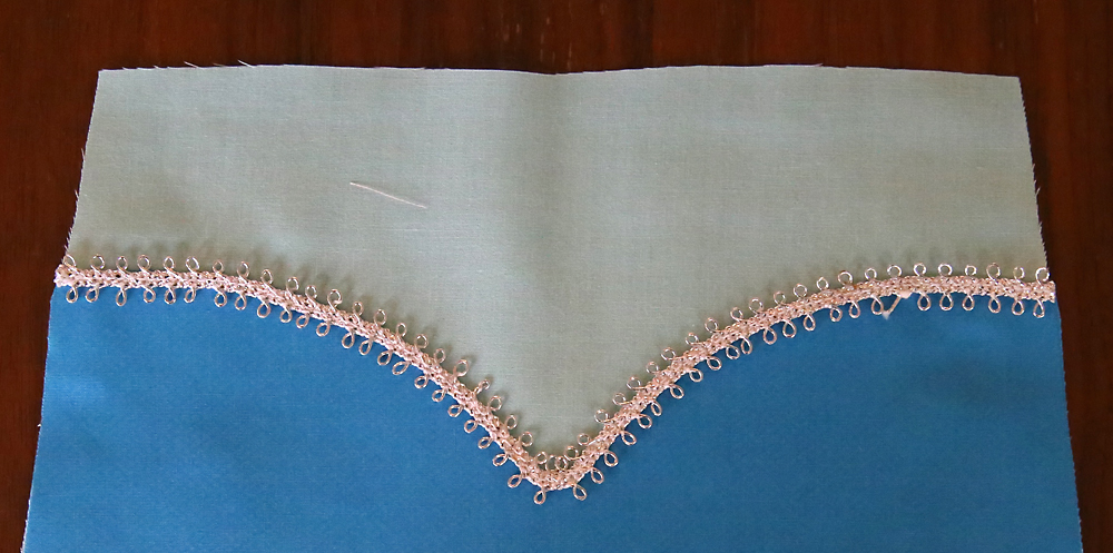 Silver trim placed over seam between two bodice pieces