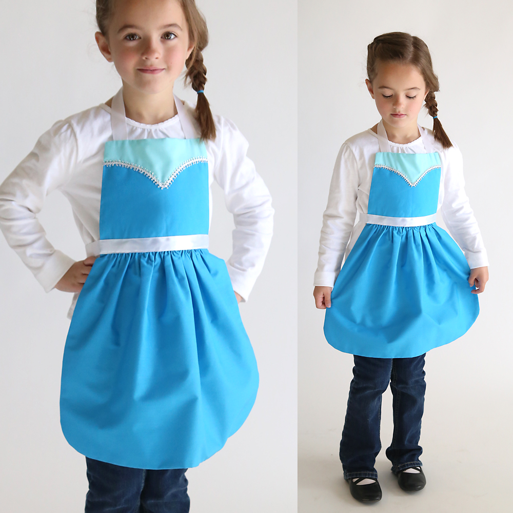 A girl in a blue dress up apron that looks like Elsa princess from Frozen
