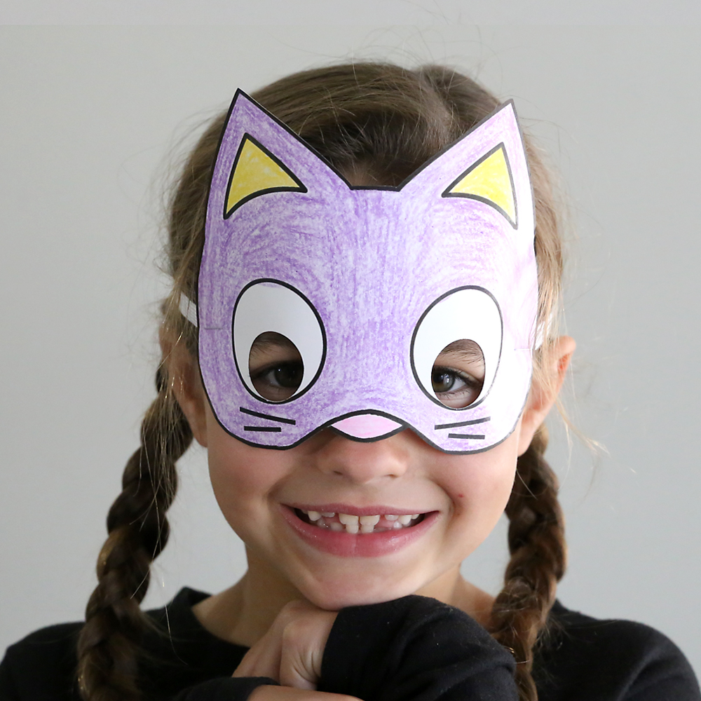 Girl wearing paper cat Halloween mask