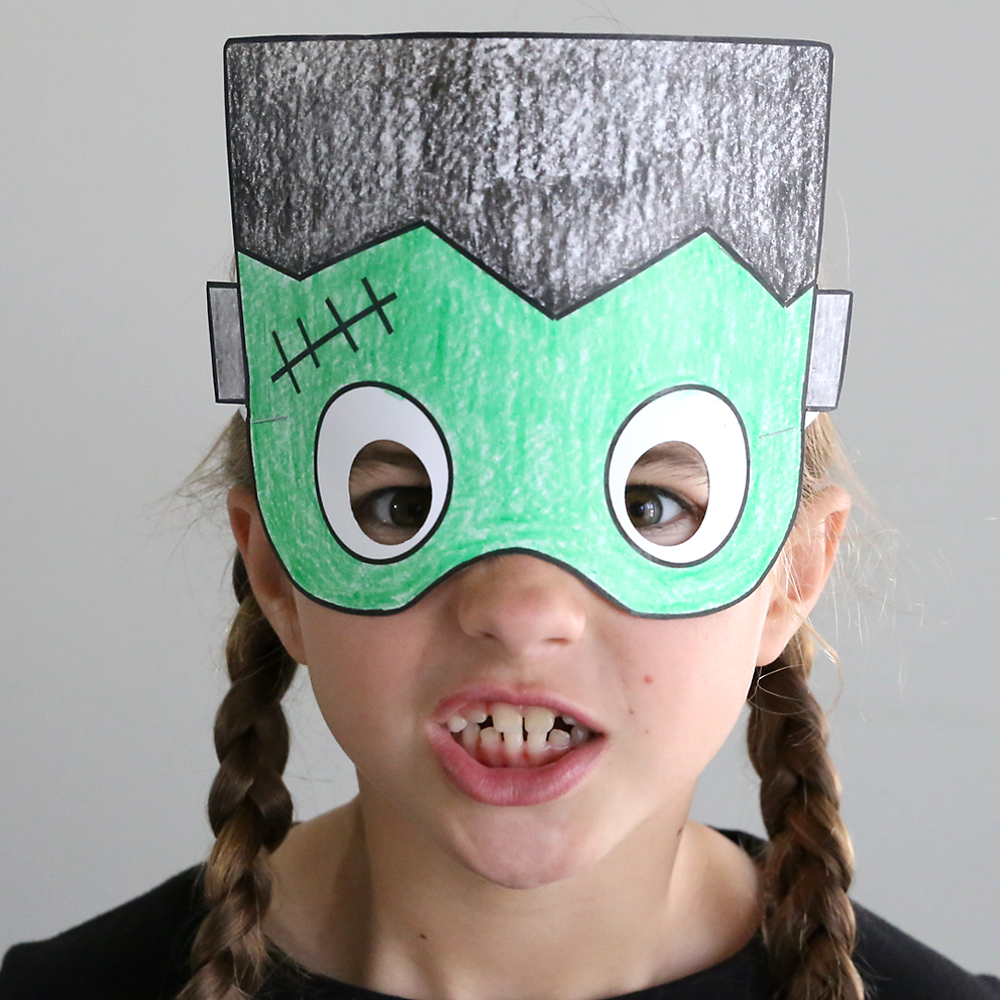 Girl wearing paper Frankenstein Halloween mask