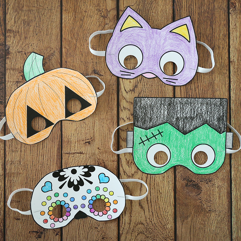 Paper Halloween masks that have been colored with crayons