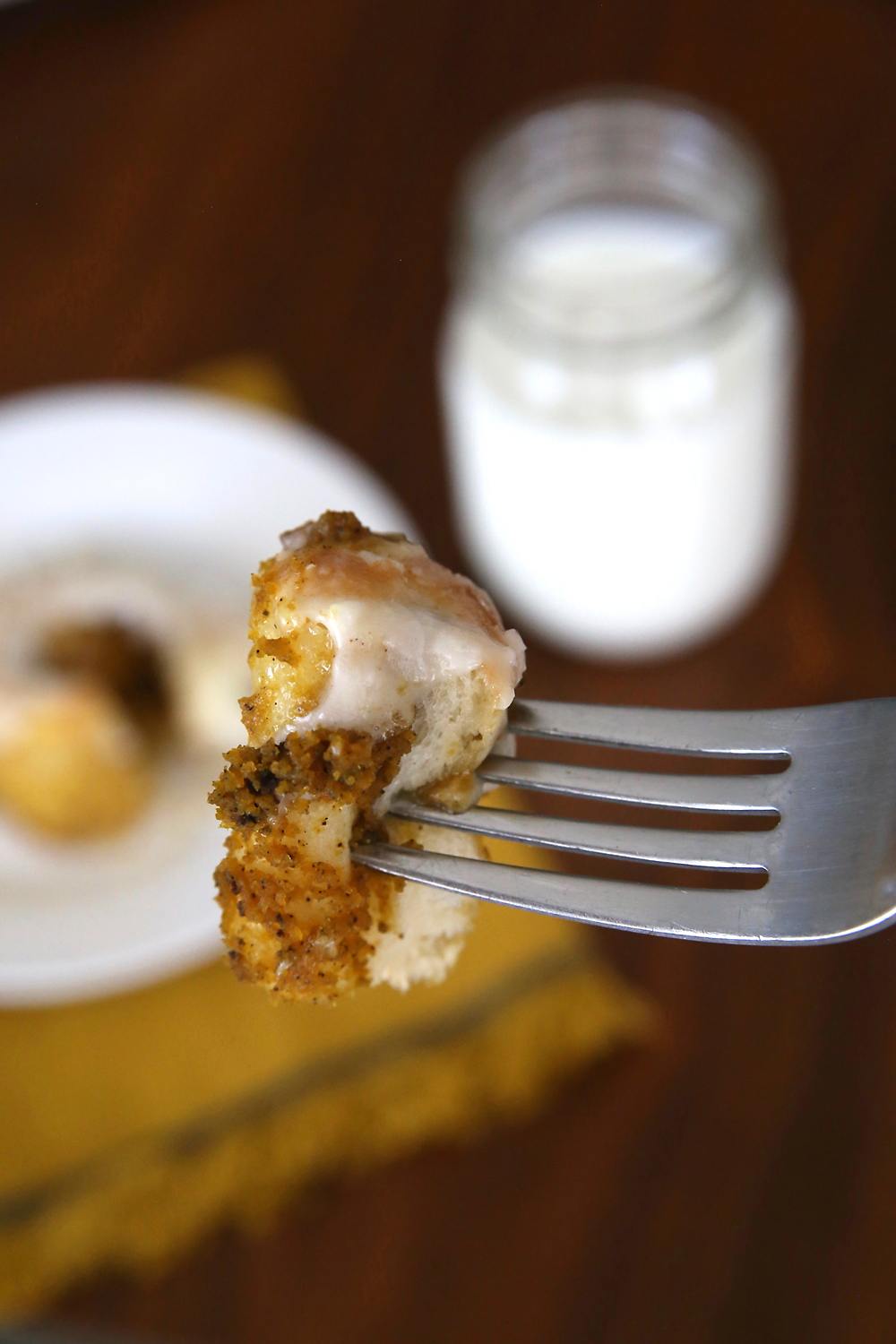 bite of pumpkin pie cinnamon roll on a fork