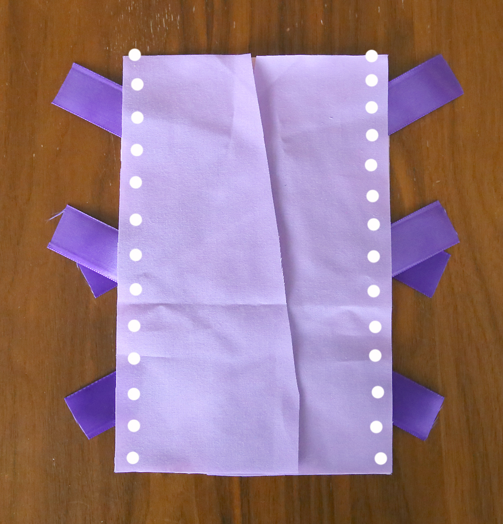 Purple fabric laid over the pink fabric and ribbon, seams marked