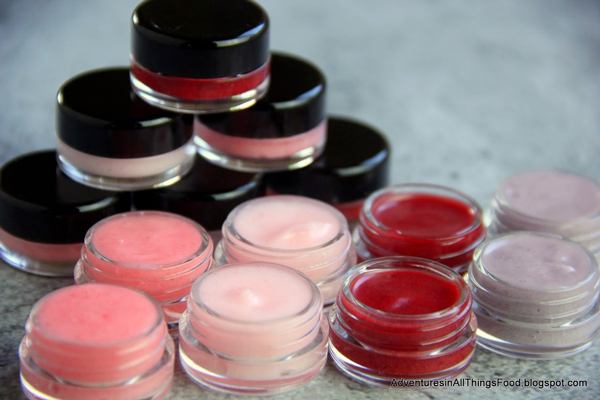 Small jars of homemade lip gloss made with Kool-Aid, in red and pink colors