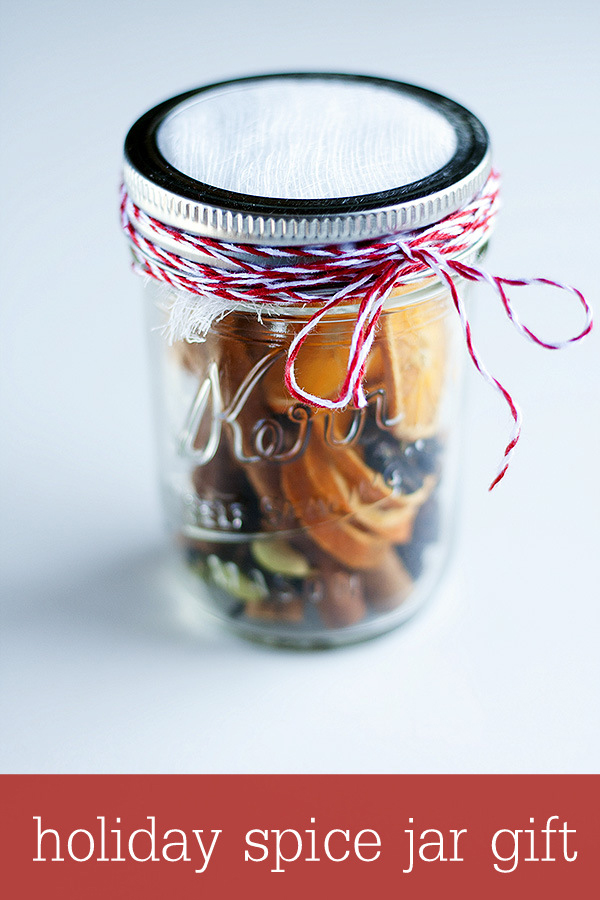 Christmas potpourri ingredients in a mason jar tied with twine