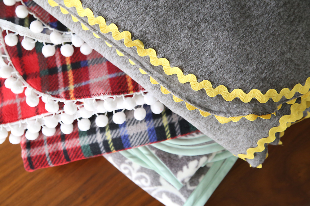 Three fleece blankets with different trims 