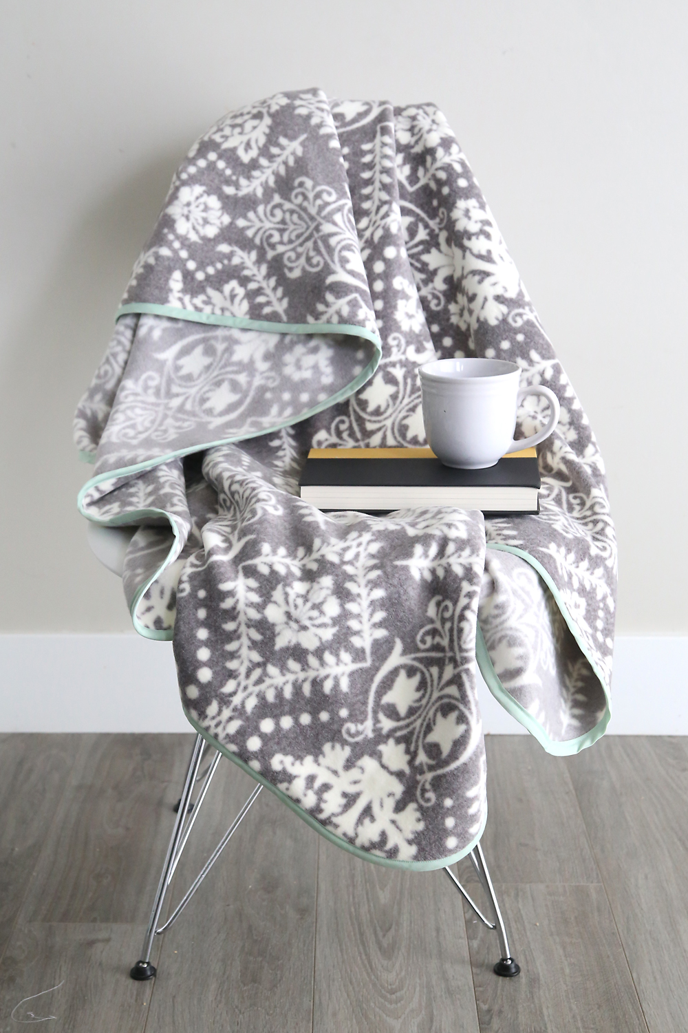 DIY fleece blanket with bias trim draped over a chair