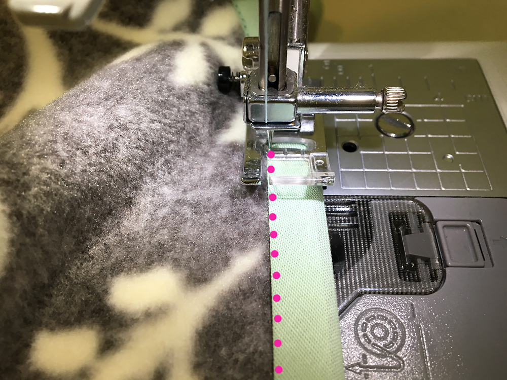Fleece with bias tape over the edge on the sewing machine