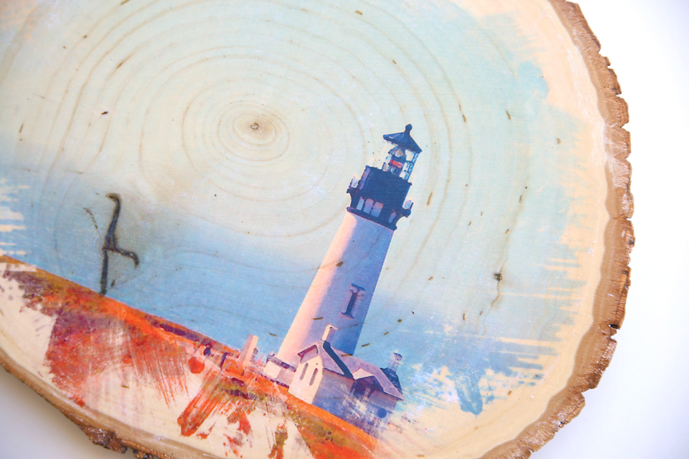 Closeup of a lighthouse photo transferred onto a wood slice