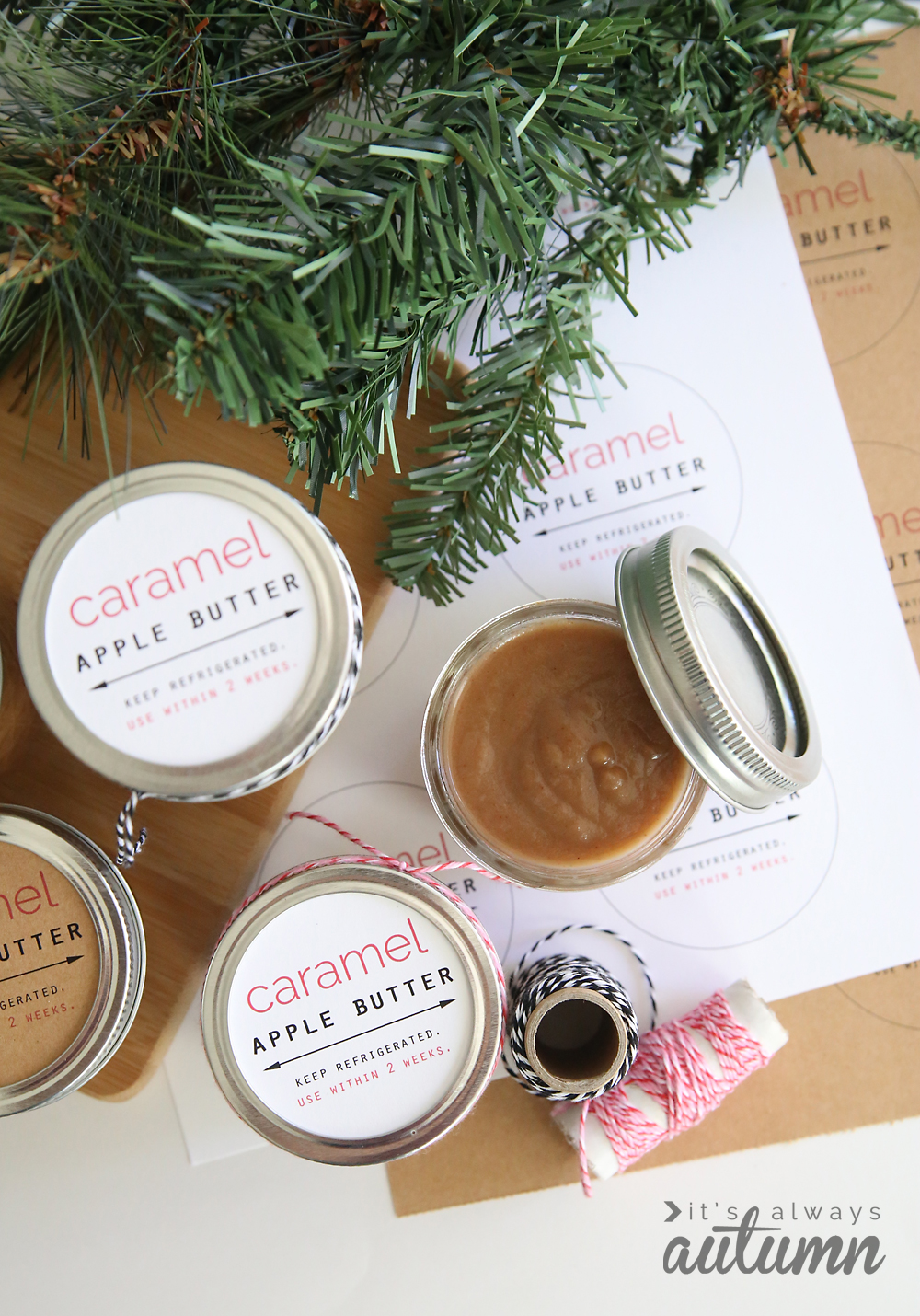 Small jars full of caramel apple butter with gift tags and twine