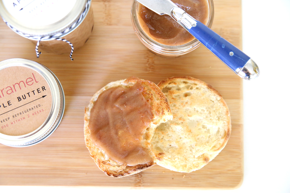 Toasted English muffin spread with caramel apple butter, jar of apple butter