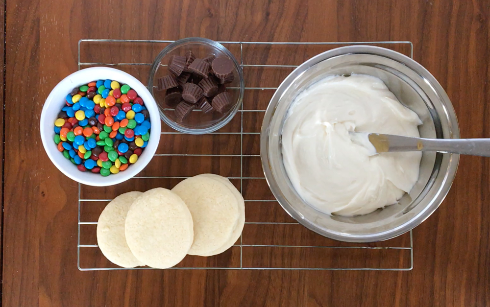 Sugar cookies with frosting, M&Ms and mini Reeses cups