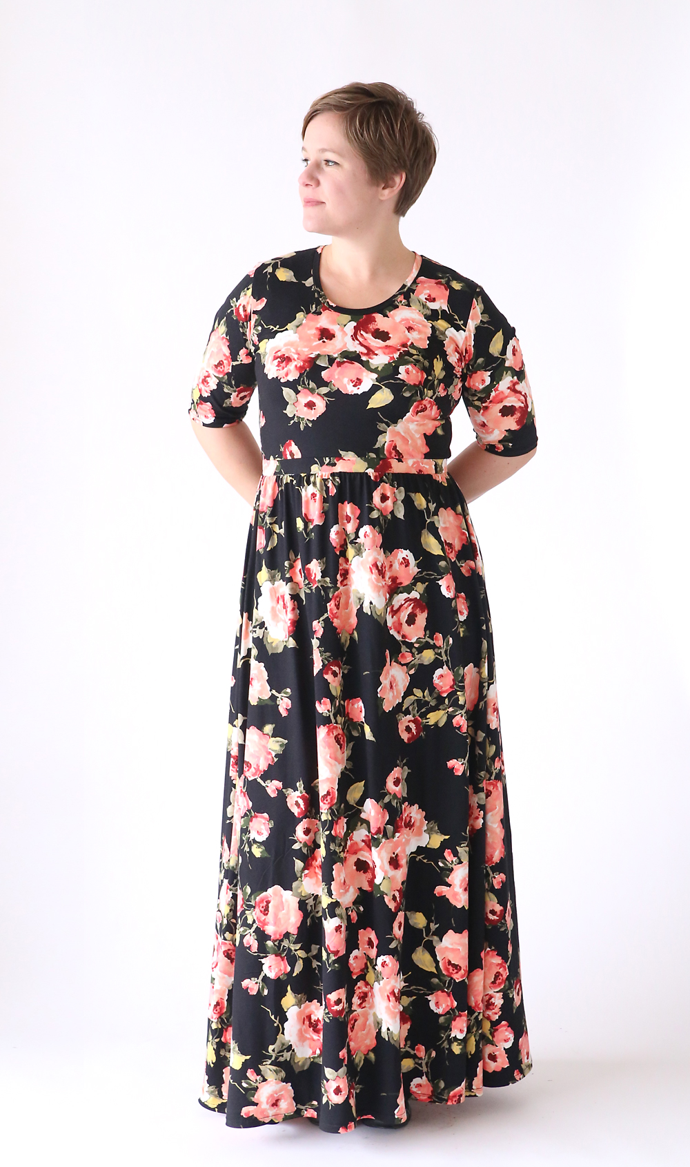 A woman wearing a black floral maxi dress