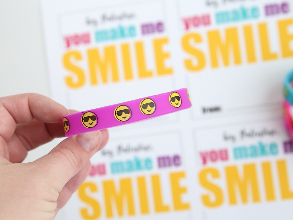 Close up of emoji bracelet and printable Valentine\'s cards