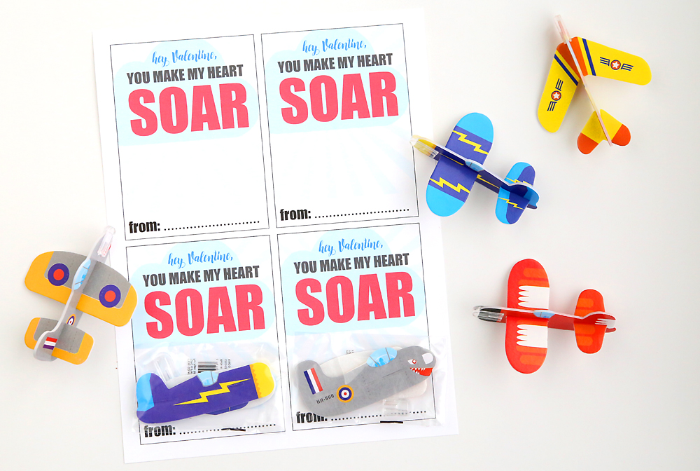 Cute DIY Valentine's Day card with mini airplanes / gliders. Perfect for boys! Free printable Valentine card. Easy & cheap idea - enough for two classrooms of kids for under $10!
