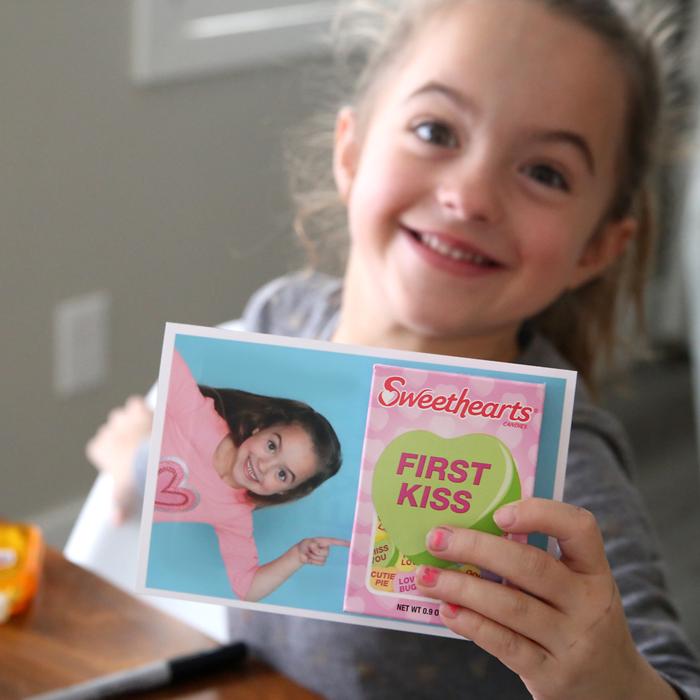 Girl holding a sweethearts valentines day photo card